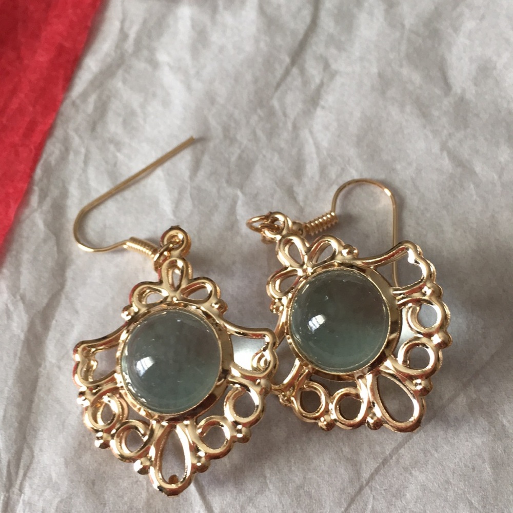 Gold tone earrings with clear ball in middle
